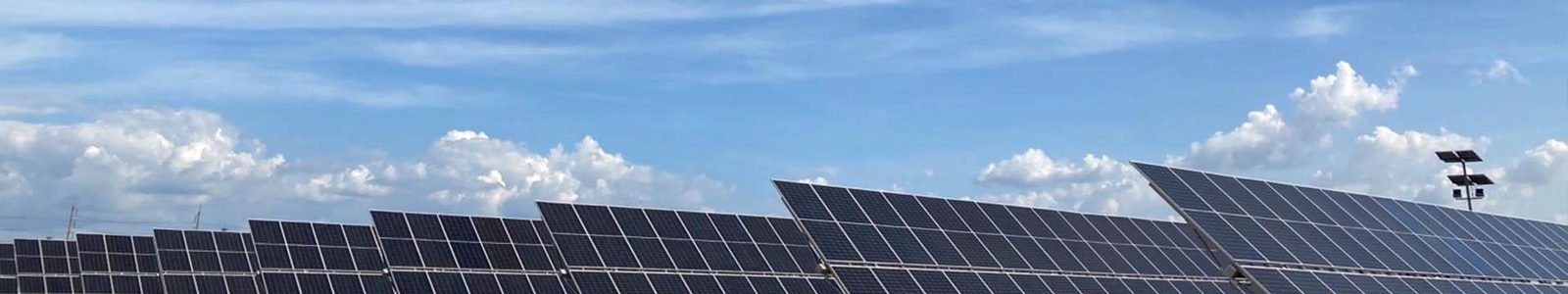 Auric Energy solar panel array under a clear blue sky